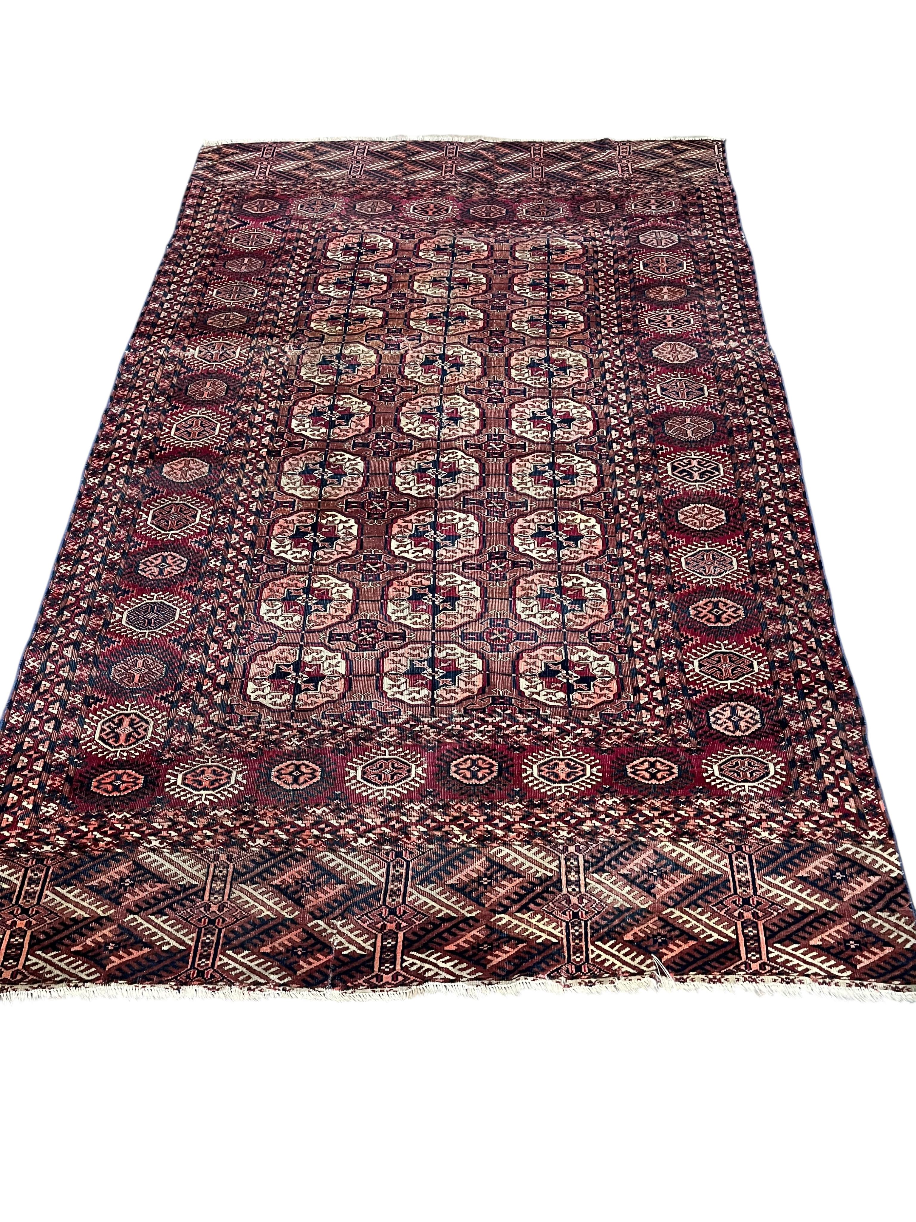 A Bokhara red ground rug, 190 x 132cm